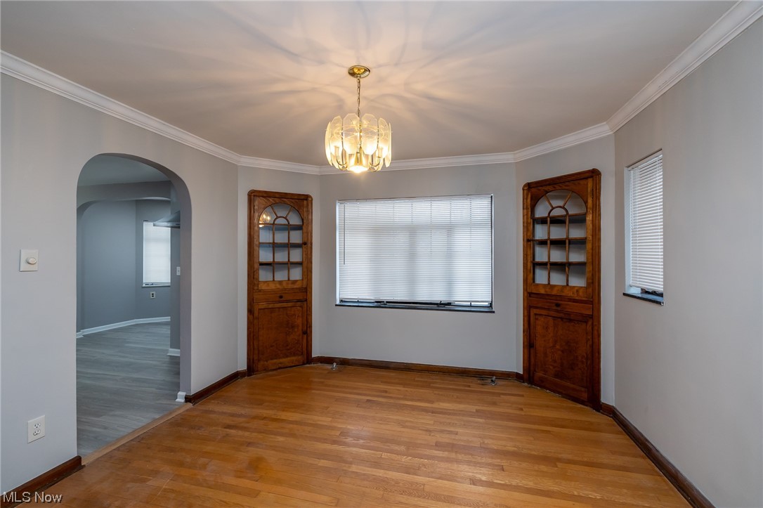 4668 Broadale Road Cleveland, OH 44109 - Photo 10 of 25 Foyer with ornamental molding, an inviting chandelier, a wealth of natural light, and light wood-type flooring