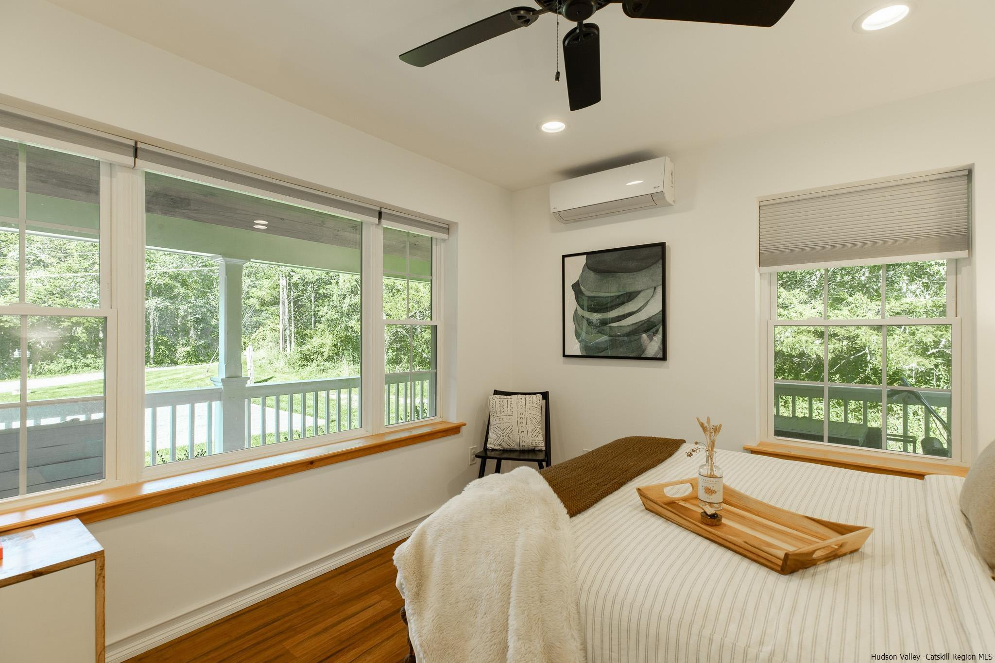 13 Lamberti Lane Stone Ridge, NY 12484 - Photo 11 of 35 a bedroom with a bed and a large window with swimming pool view