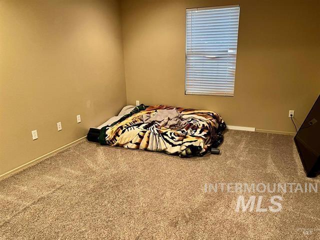 6498 South Lighthouse Place Boise, ID 83709 - Photo 11 of 16 Carpeted bedroom featuring baseboards
