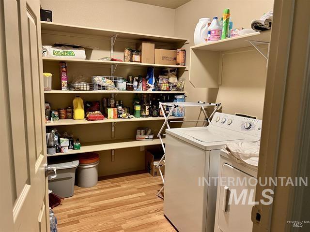 6498 South Lighthouse Place Boise, ID 83709 - Photo 13 of 16 Laundry room with light wood-type flooring and independent washer and dryer