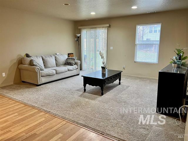 6498 South Lighthouse Place Boise, ID 83709 - Photo 4 of 16 Living area featuring recessed lighting, light wood-type flooring, and a textured ceiling