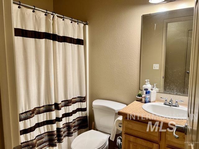 6498 South Lighthouse Place Boise, ID 83709 - Photo 10 of 16 Full bathroom featuring a textured wall, vanity, and curtained shower