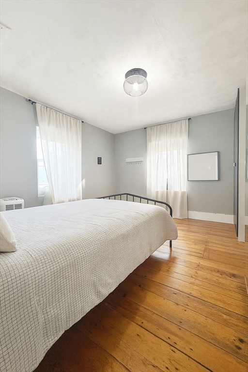 74 Davison Street Boston, MA 02136 - Photo 12 of 20 a spacious bedroom with a bed and wooden floor