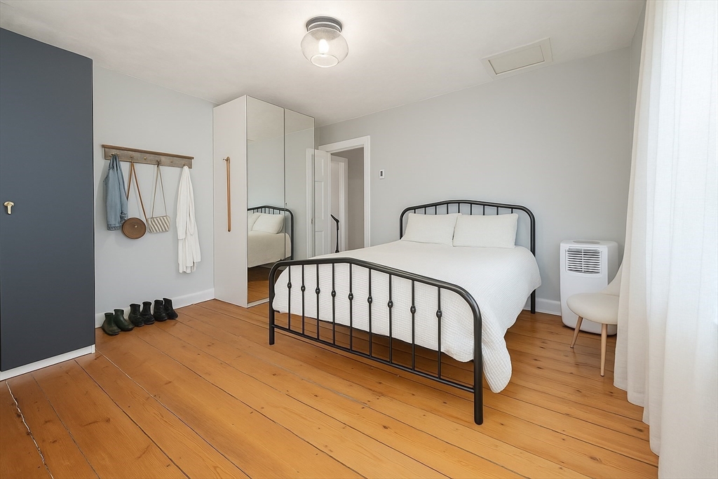 74 Davison Street Boston, MA 02136 - Photo 13 of 20 a bedroom with a bed and wooden floor