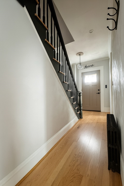 74 Davison Street Boston, MA 02136 - Photo 16 of 20 a view of a hallway with wooden floor and staircase