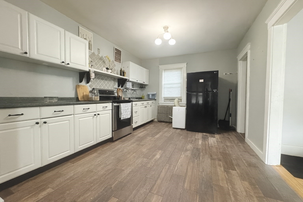 74 Davison Street Boston, MA 02136 - Photo 4 of 20 a kitchen with stainless steel appliances granite countertop a refrigerator and a stove top oven