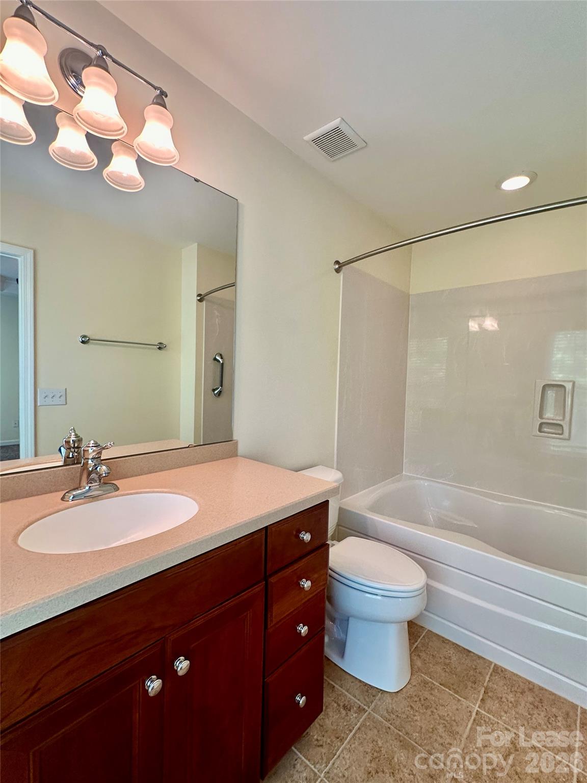 1104 Drayton Court Fort Mill, SC 29708 - Photo 15 of 20 a bathroom with a sink a toilet a mirror a vanity and bathtub