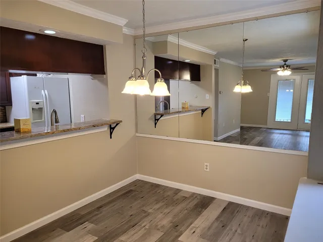a view of a kitchen with a sink and wooden floor
