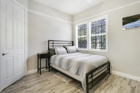 a bed sitting in a bedroom next to a window