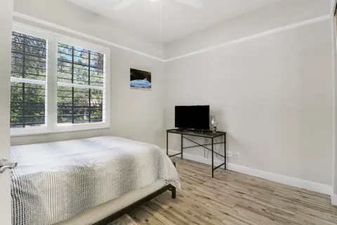 a bedroom with a bed and a flat screen tv