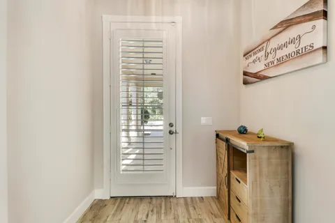 a view of a hallway with closet and front door
