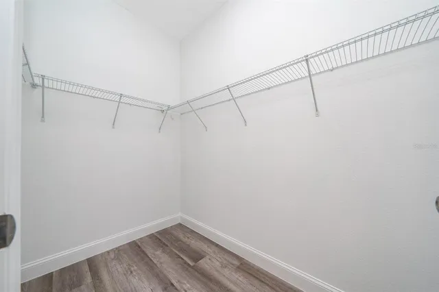 a spacious bathroom with double sink and a mirror