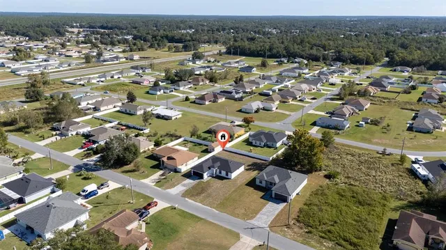 an aerial view of a house with a yard