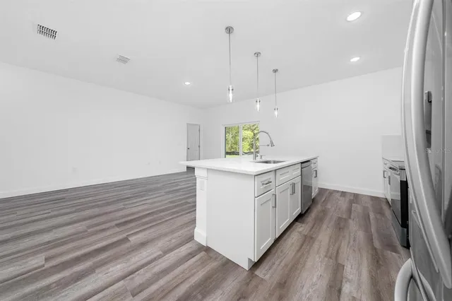 a kitchen with a white stove cabinets and wooden floor