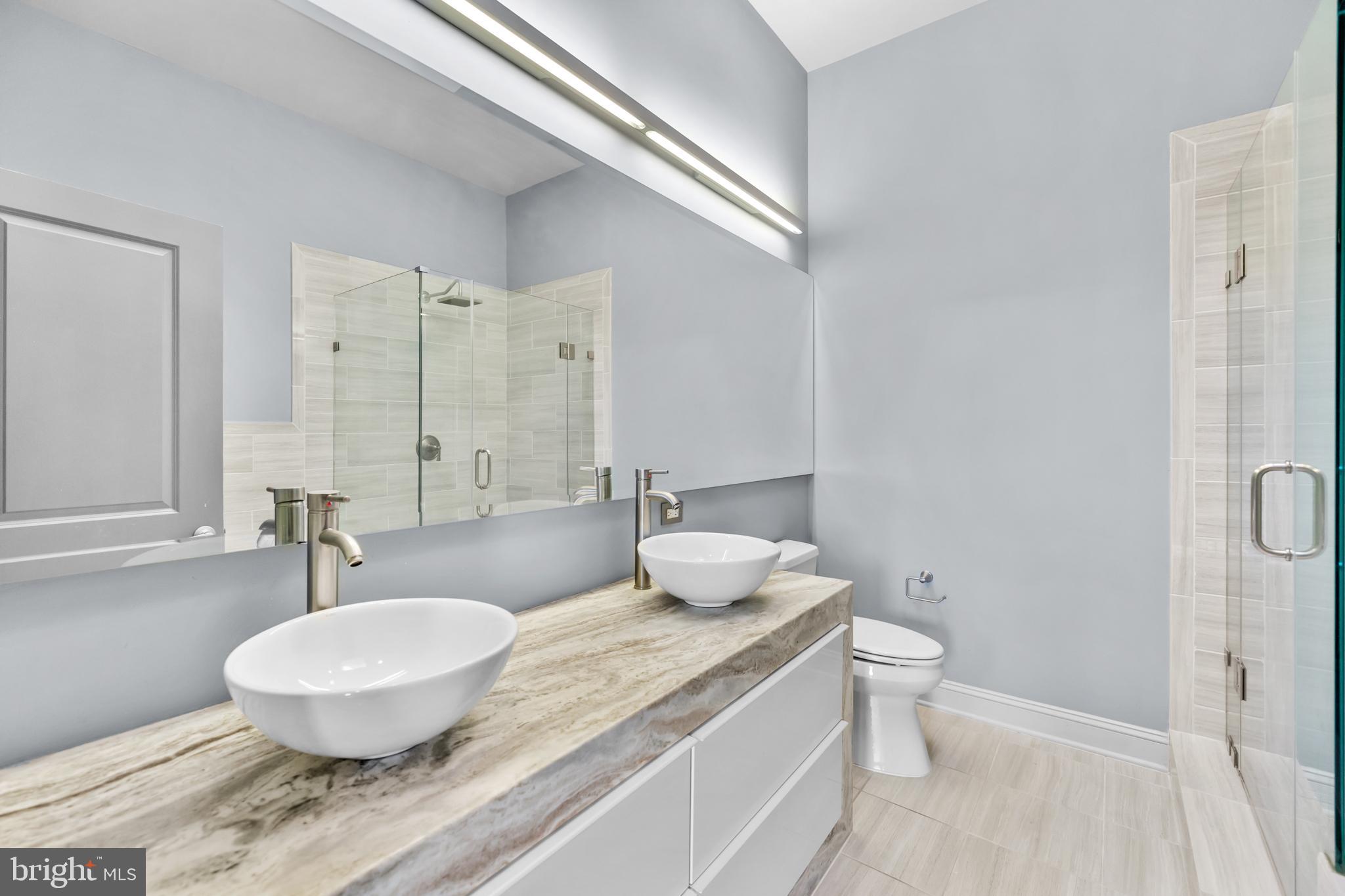 151 V Street Northwest, Unit 4 Washington, DC 20001 - Photo 33 of 49 a bathroom with a granite countertop sink and a mirror