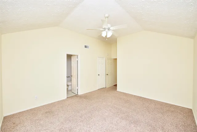 a view of a room with a ceiling fan and a window