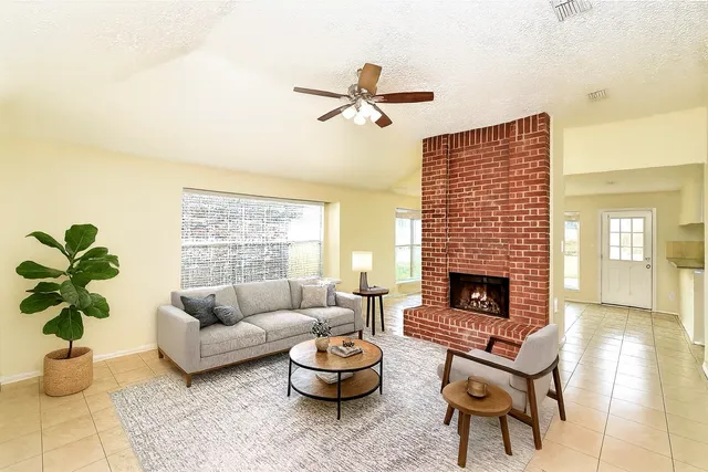 a living room with furniture and a fireplace