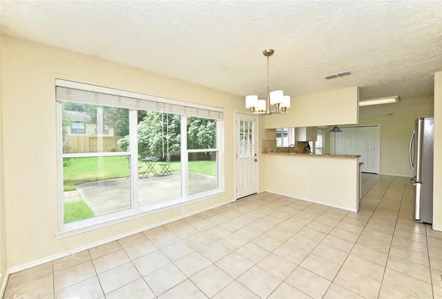 a view of a kitchen with furniture and an empty room