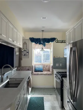 a kitchen with a sink cabinets and stainless steel appliances