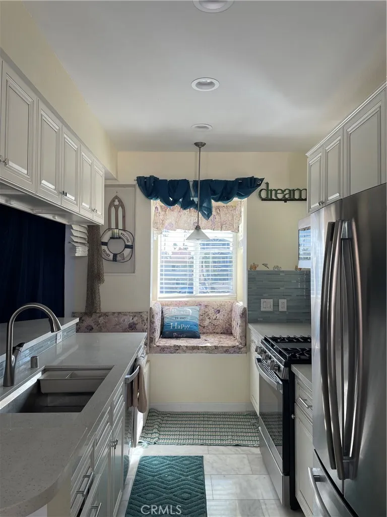 222 9th Street Huntington Beach, CA 92648 - Photo 7 of 13 a kitchen with a sink and refrigerator