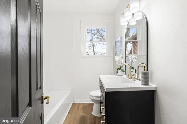 a bathroom with a sink toilet and a mirror