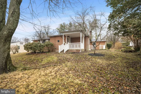 a backyard of a house with large trees and barbeque oven