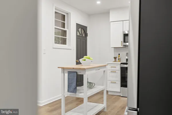 a hallway with a white cabinets and chairs