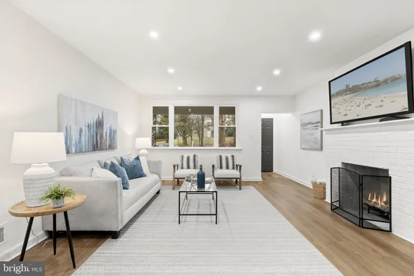 a living room with furniture a window and a fireplace