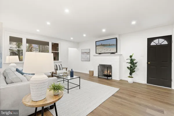 a living room with furniture fireplace and window