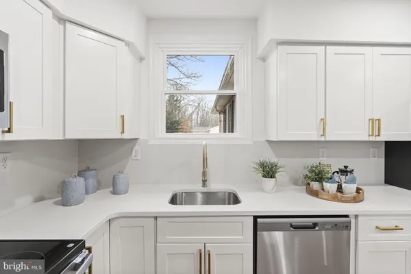 a kitchen with a sink cabinets and window