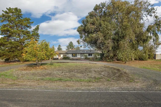 a view of house with outdoor space and trees