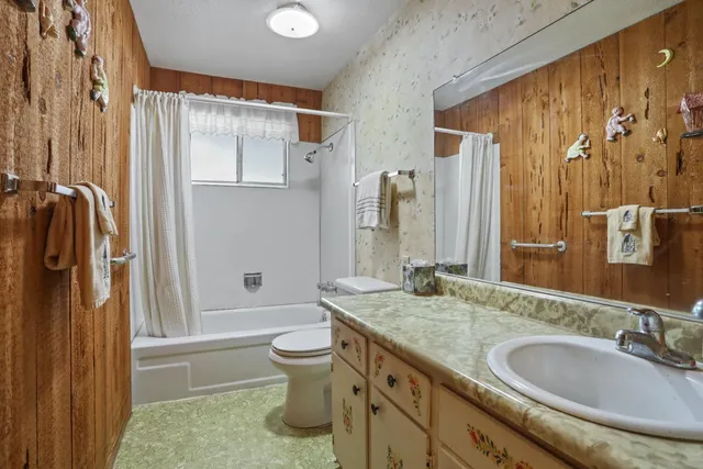 a view of an empty room with window and bathroom