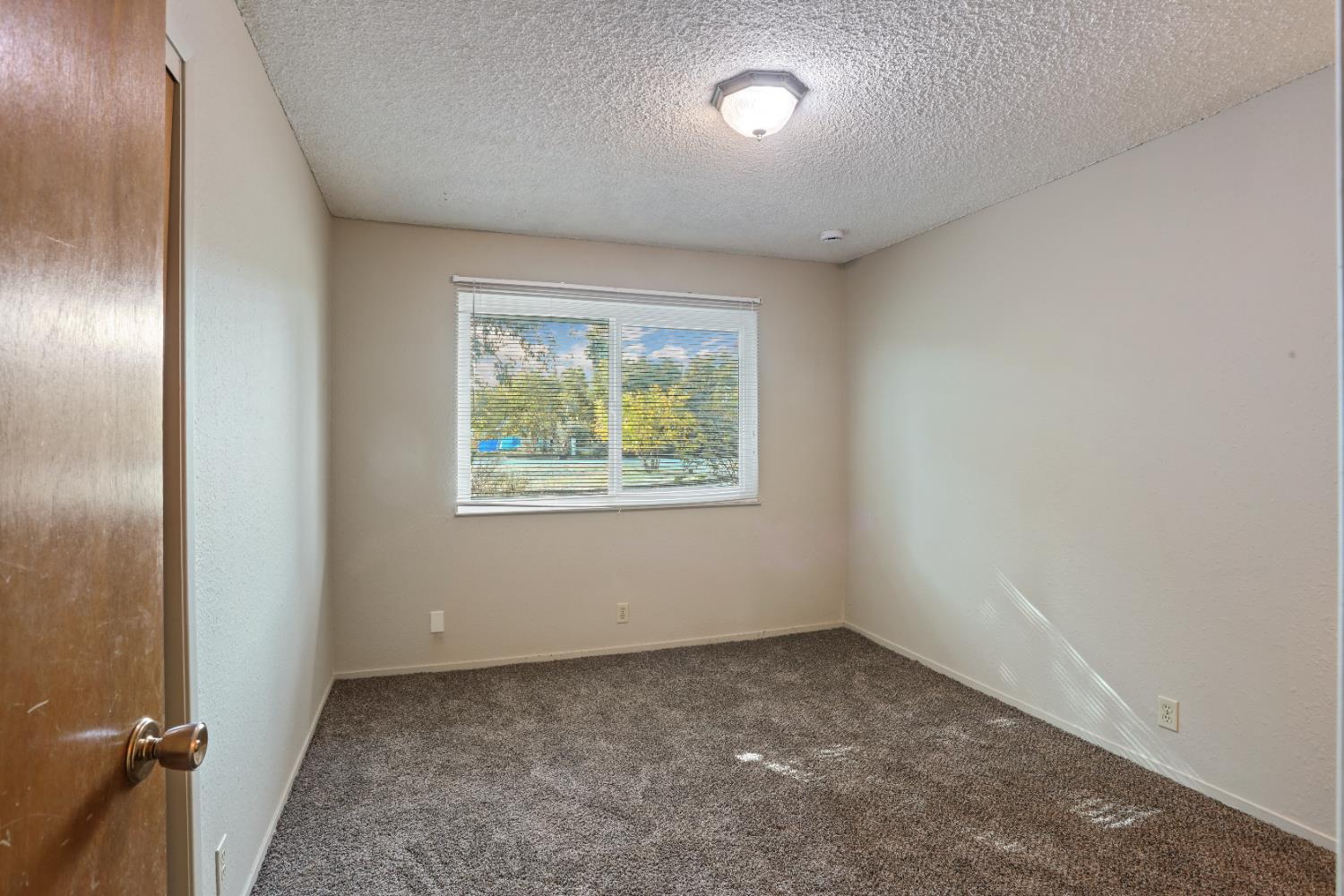 25523 East Groves Road Farmington, CA 95230 - Photo 21 of 65 an empty room with windows