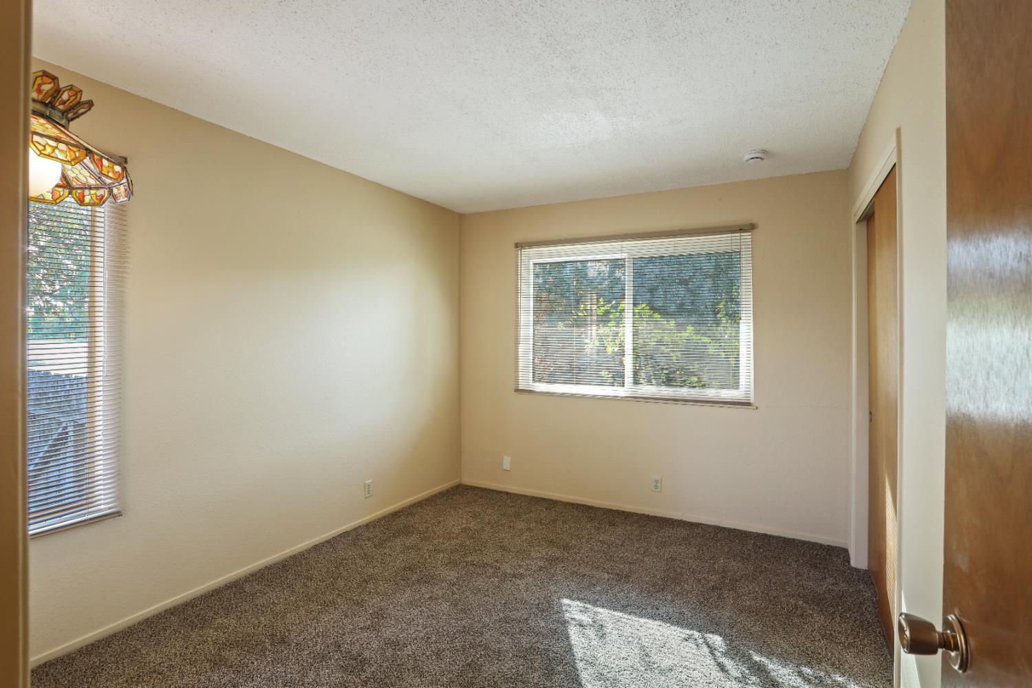 25523 East Groves Road Farmington, CA 95230 - Photo 23 of 65 an empty room with windows
