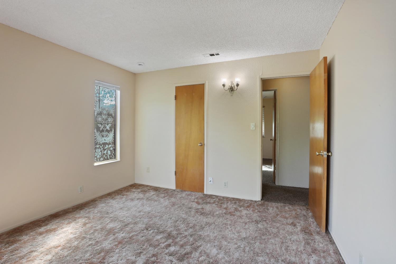 25523 East Groves Road Farmington, CA 95230 - Photo 26 of 65 a view of an empty room with window and bathroom