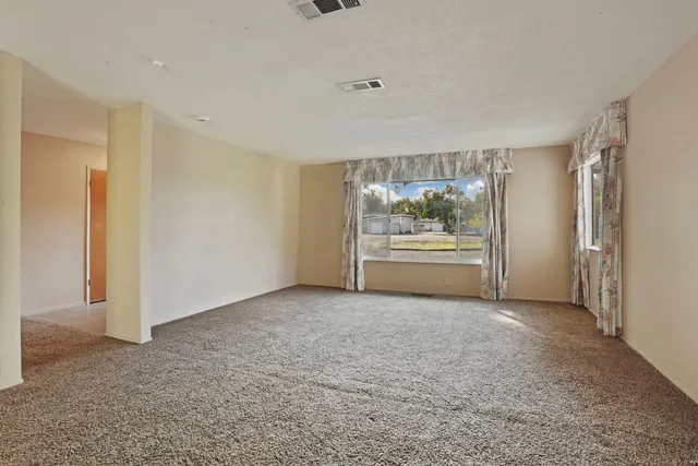 a room with pool table and a window