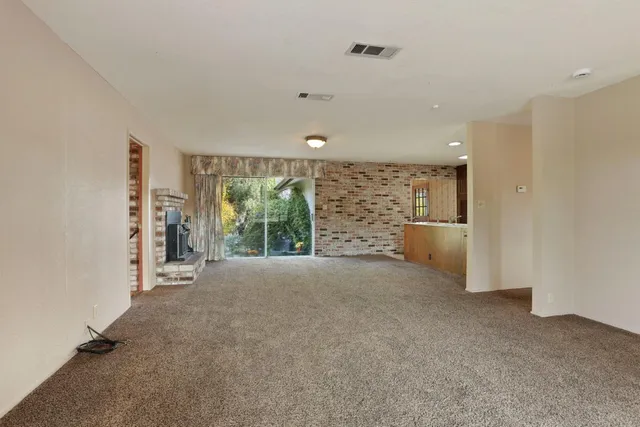 a room with pool table and windows