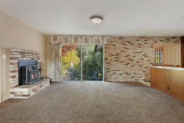 a kitchen with stainless steel appliances granite countertop a refrigerator a stove and a sink with wooden cabinets