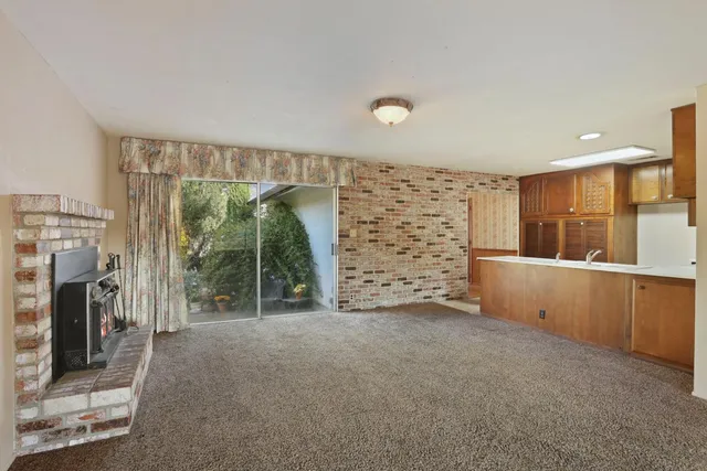 a kitchen with granite countertop stainless steel appliances a refrigerator and a sink