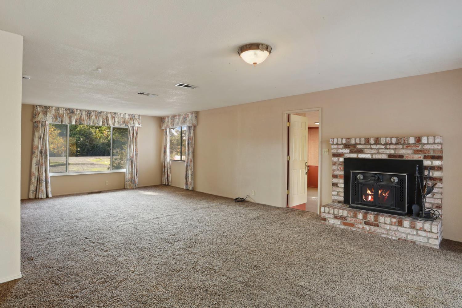 25523 East Groves Road Farmington, CA 95230 - Photo 34 of 65 a view of empty room with a fireplace