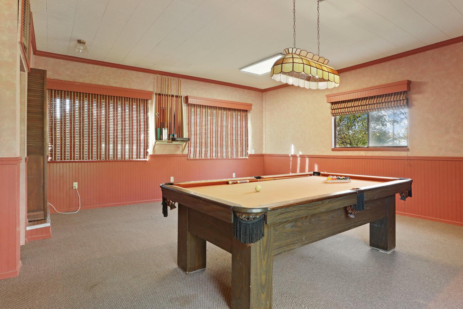 25523 East Groves Road Farmington, CA 95230 - Photo 36 of 65 a room with chandelier furniture and windows