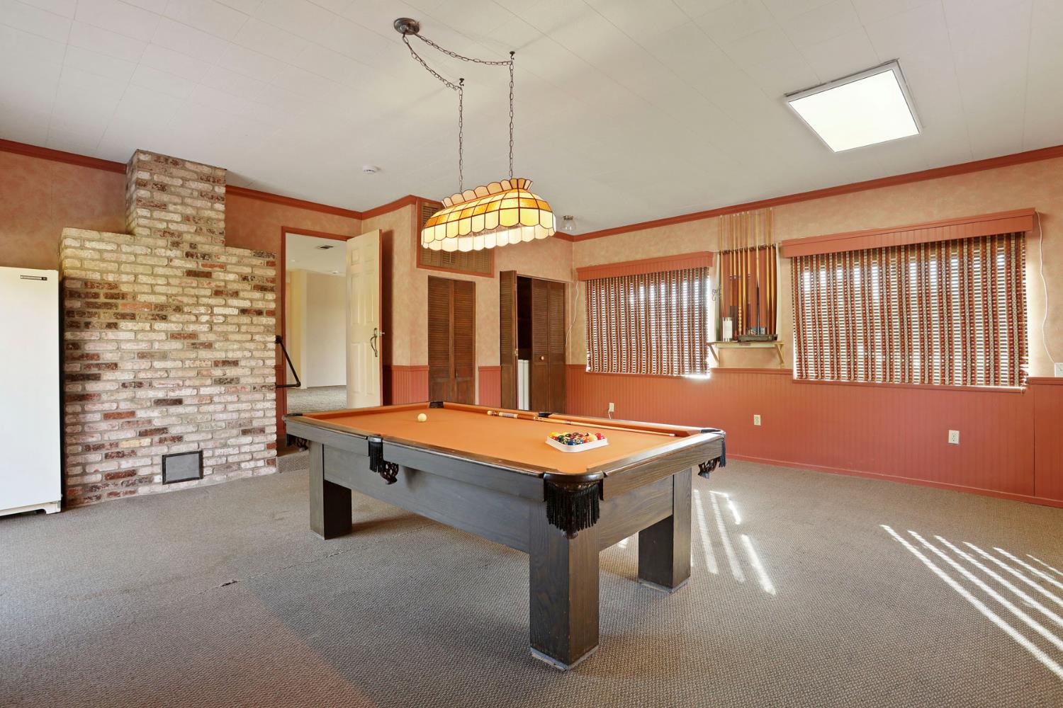 25523 East Groves Road Farmington, CA 95230 - Photo 37 of 65 a room with pool table and windows