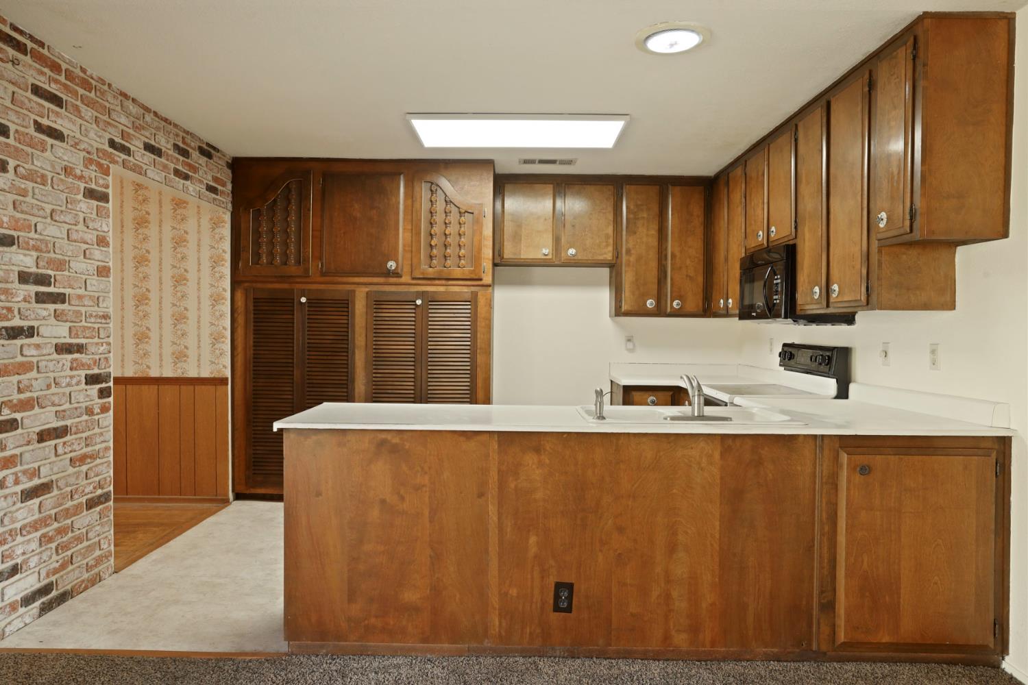 25523 East Groves Road Farmington, CA 95230 - Photo 40 of 65 a kitchen with stainless steel appliances granite countertop a refrigerator a stove and a sink with wooden cabinets