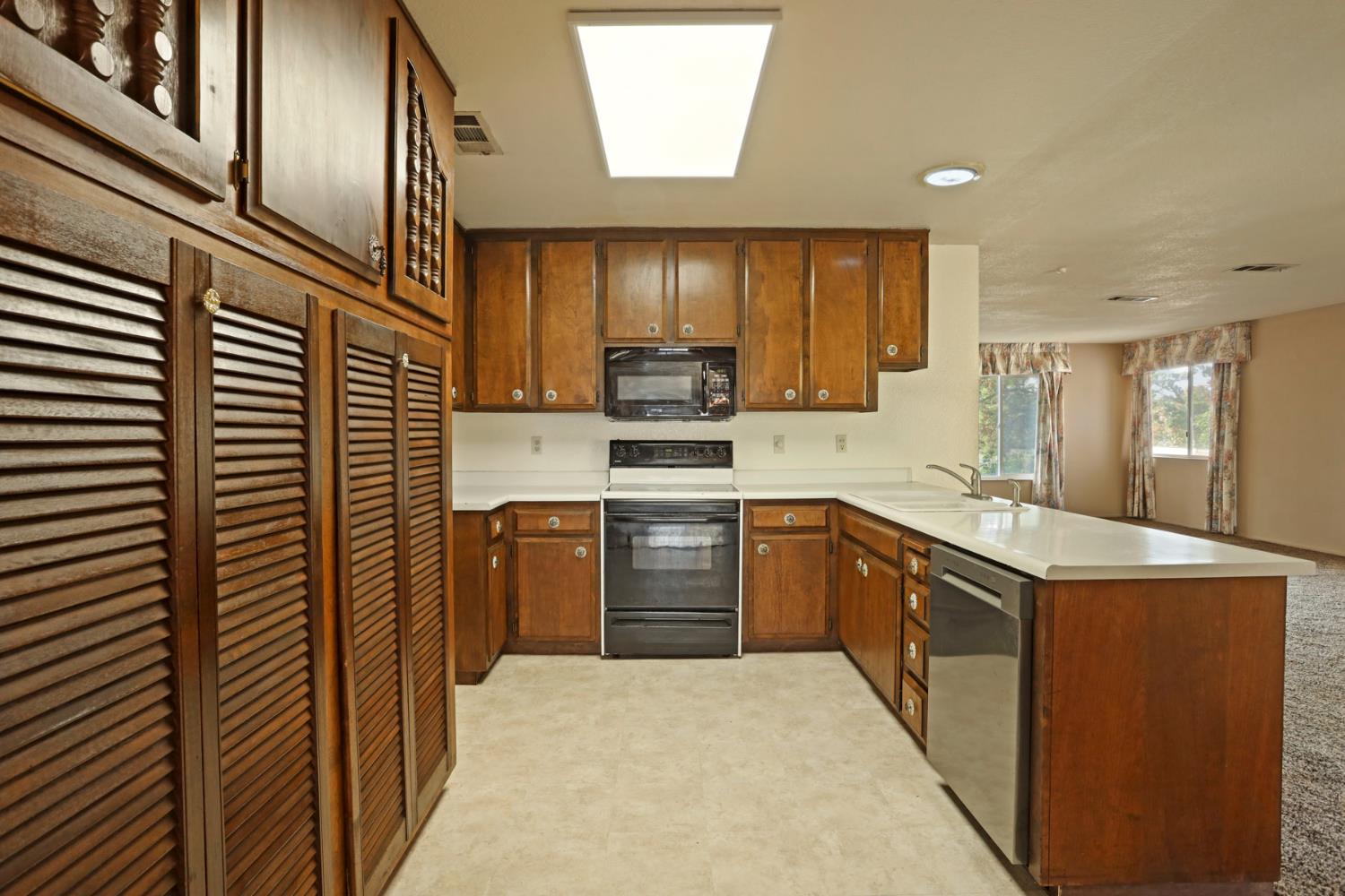 25523 East Groves Road Farmington, CA 95230 - Photo 42 of 65 a kitchen with stainless steel appliances granite countertop a stove a sink and a refrigerator