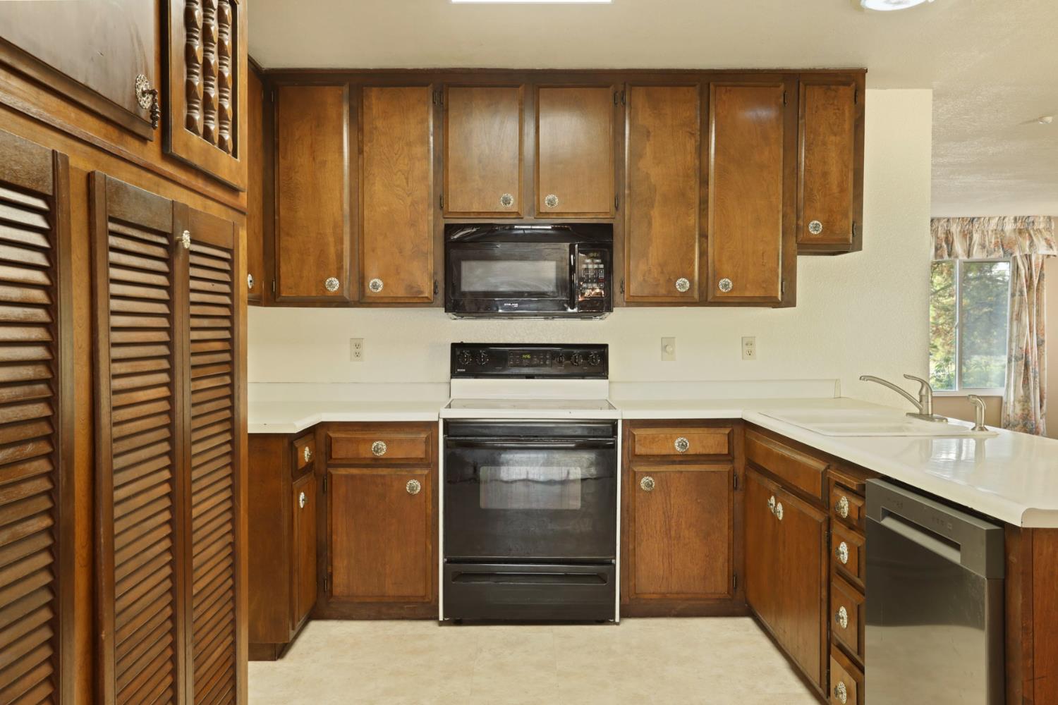 25523 East Groves Road Farmington, CA 95230 - Photo 43 of 65 a kitchen with a sink and cabinets