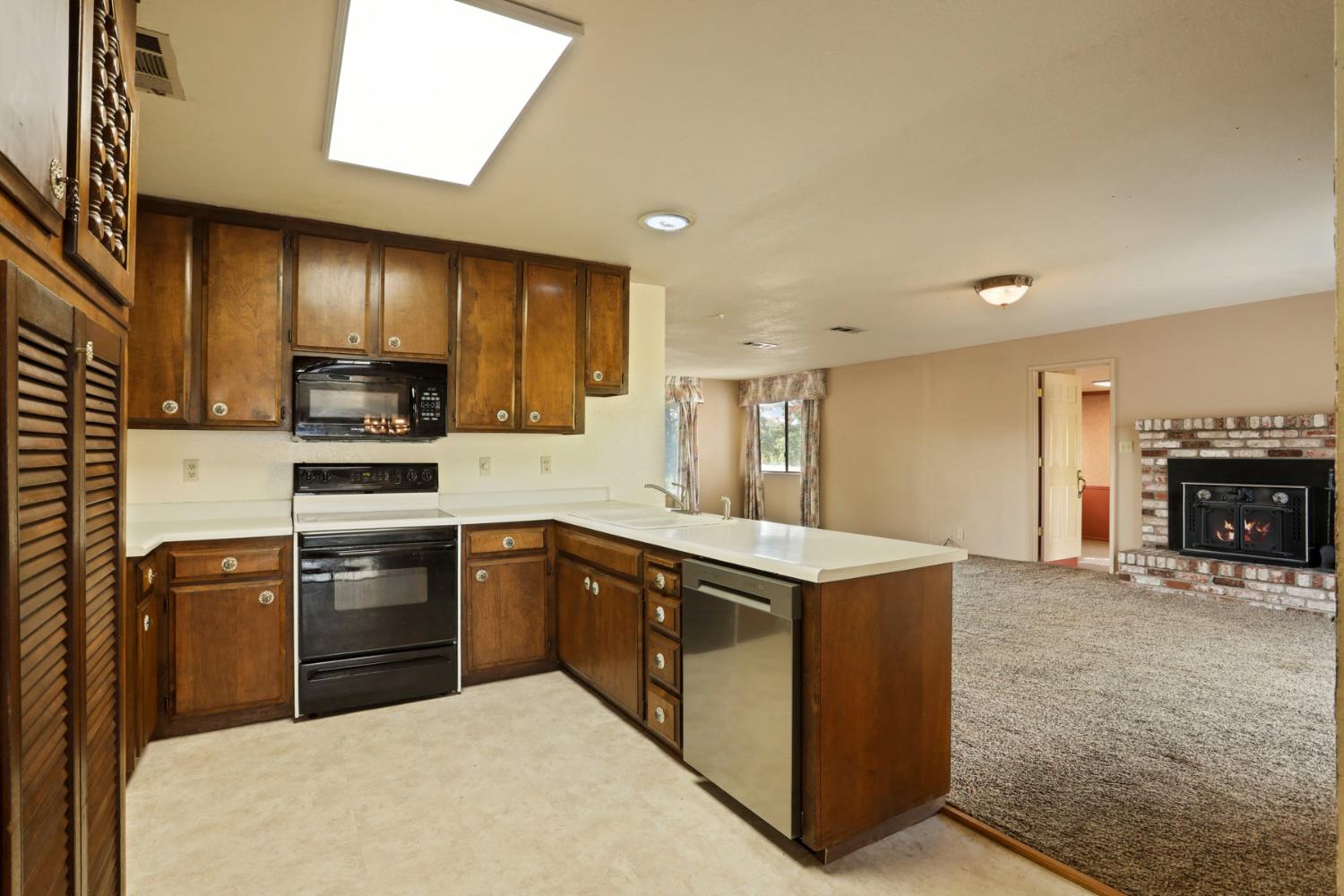 25523 East Groves Road Farmington, CA 95230 - Photo 45 of 65 a kitchen with stainless steel appliances granite countertop a sink stove and refrigerator