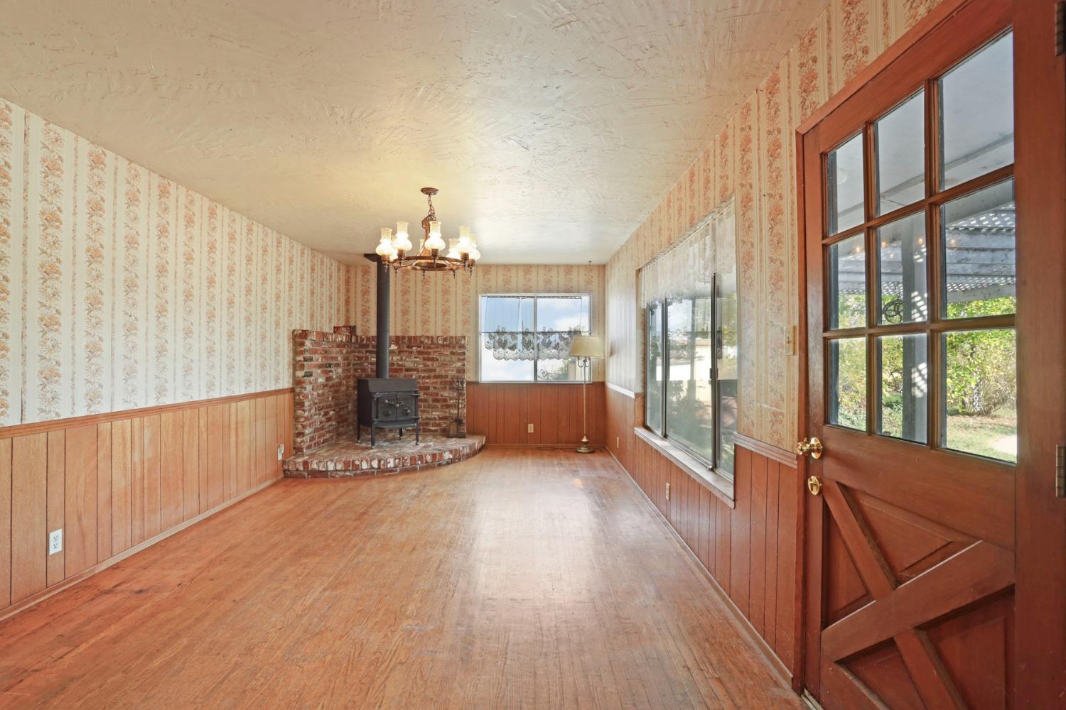 25523 East Groves Road Farmington, CA 95230 - Photo 46 of 65 a view of an empty room with wooden floor and a window