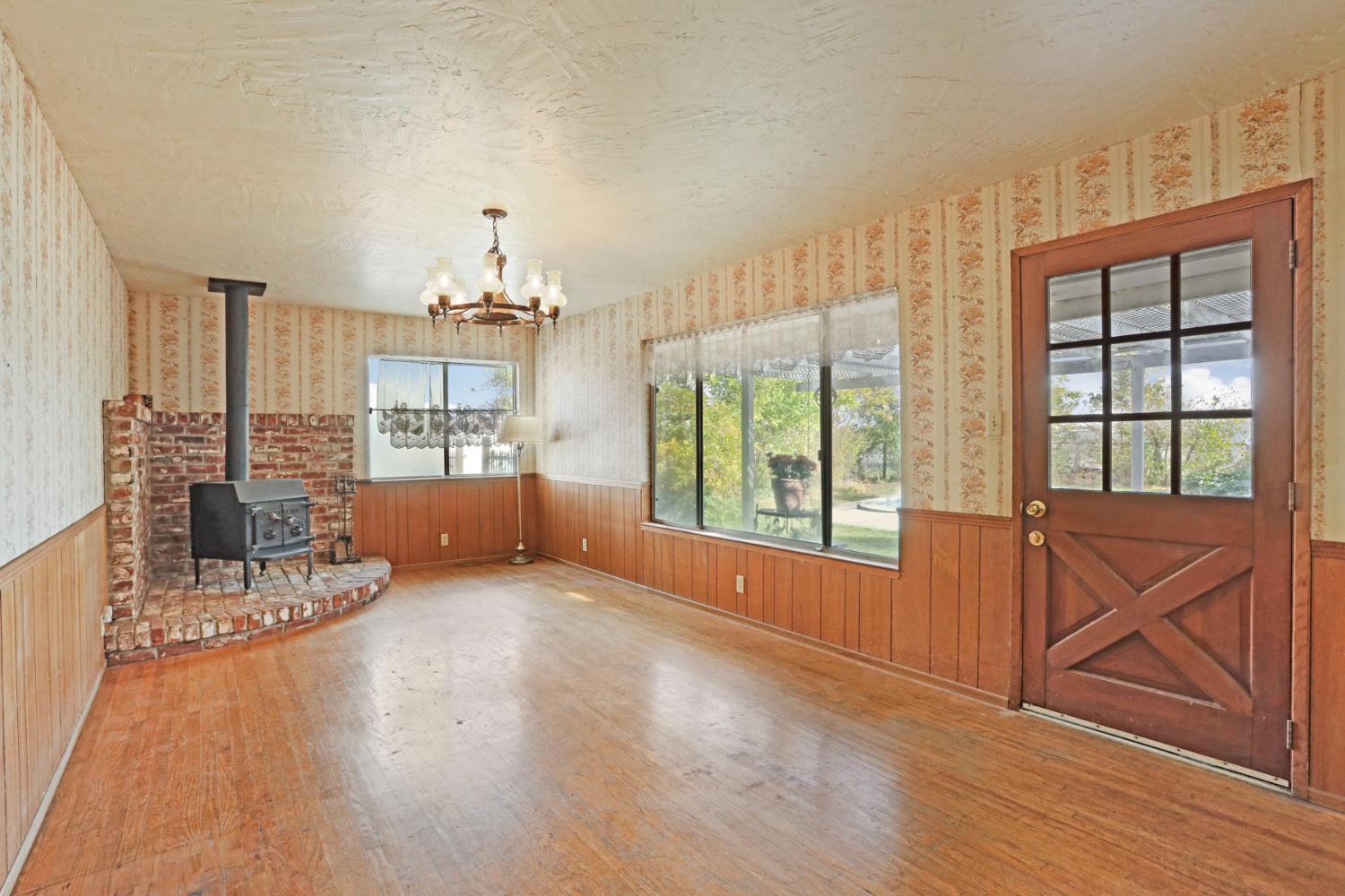 25523 East Groves Road Farmington, CA 95230 - Photo 47 of 65 a view of a livingroom with furniture wooden floor and a window