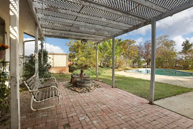 a view of a room with wooden floor and a large window