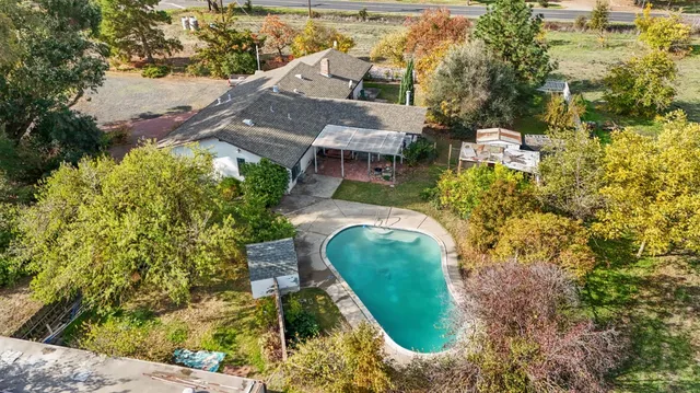 an aerial view of a house with a yard